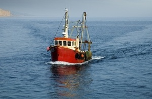red and white fishing boat at sea