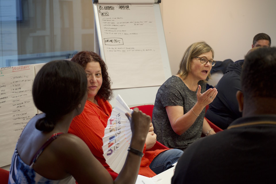 people discuss issues on a whiteboard