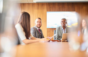 Image of people sitting at a table having a discussion