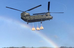 An RAF Chinook drops bags of aggregate into the Toddbrook Reservoir.