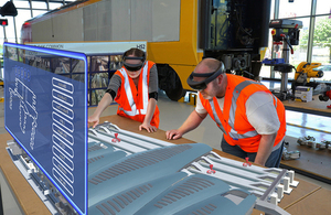 Two people with VR headsets on looking at a projected screen.