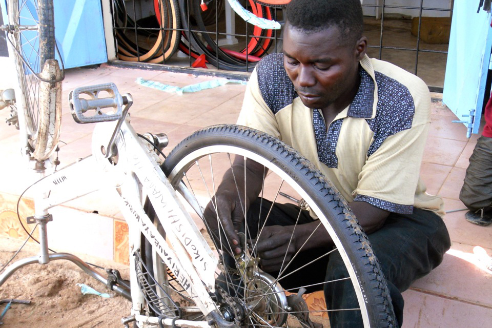 Imani Ali at work in his bike shop. Picture: AFCAP/Crown Agents