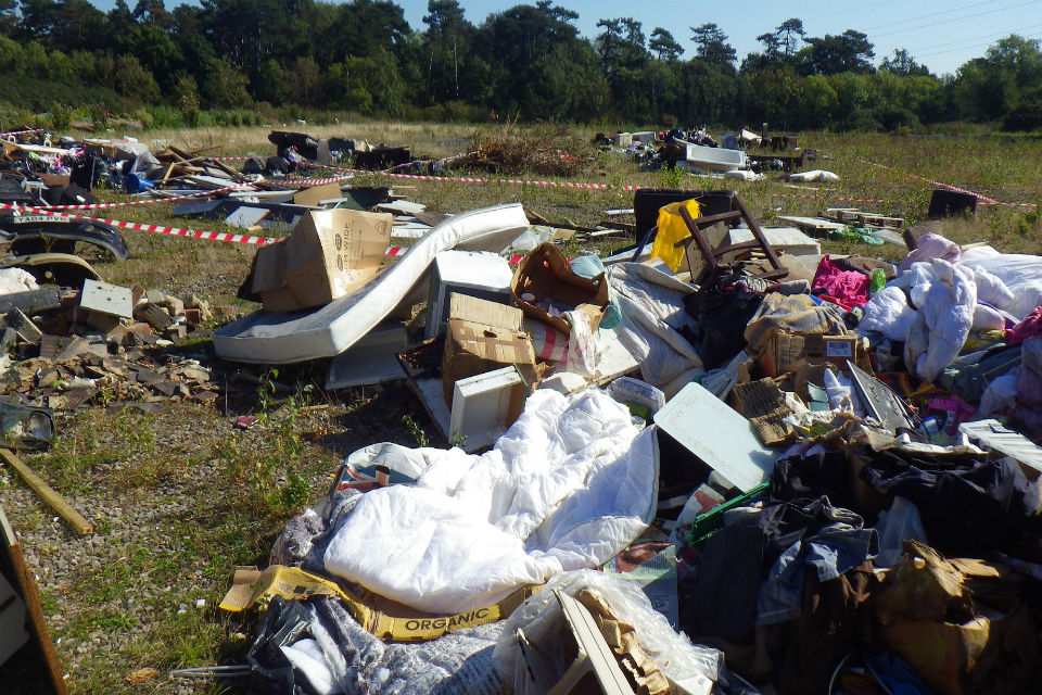 Picture shoes mattresses and duvets among the rubbish dumped on the ground