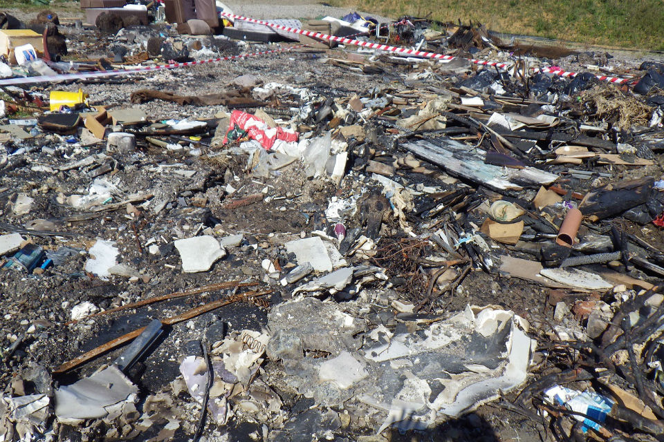 Picture shoes the blackened remains of rubbish that caught fire at the site