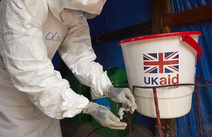 A member of an Ebola response team washes his hands a treatment centre. Credit: Unicef