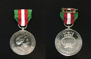 Two Merchant Navy medals on a cloth background