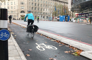Female cyclist on a city cycle path