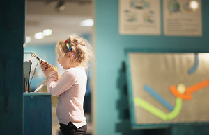 A child engages with a museum display.