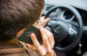 Man in car on mobile phone