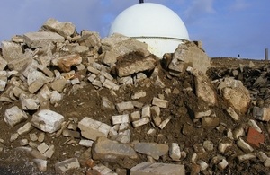 A pile of concrete rubble in front of Dounreay's Fast Reactor