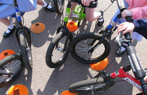 Close up view of the front wheels of a group of children's bicycles