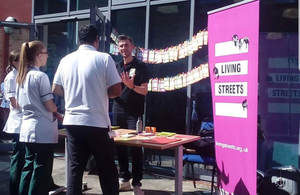 A leaving streets information stand set up outside an office building to engage staff