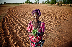 In Burkina Faso a woman shows what is left to feed her family following drought, bad crops and rising food prices. Picture: P. Tosco/Oxfam
