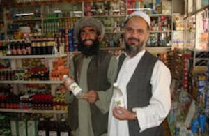 Farmer (left) supplying mint water to satisfied shopkeeper.