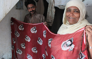 Sughra Baji proudly displays a product from her cloth embellishment business. Picture: Victoria Francis/ DFID