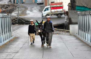 Children transporting bricks to their village. Picture: FCO