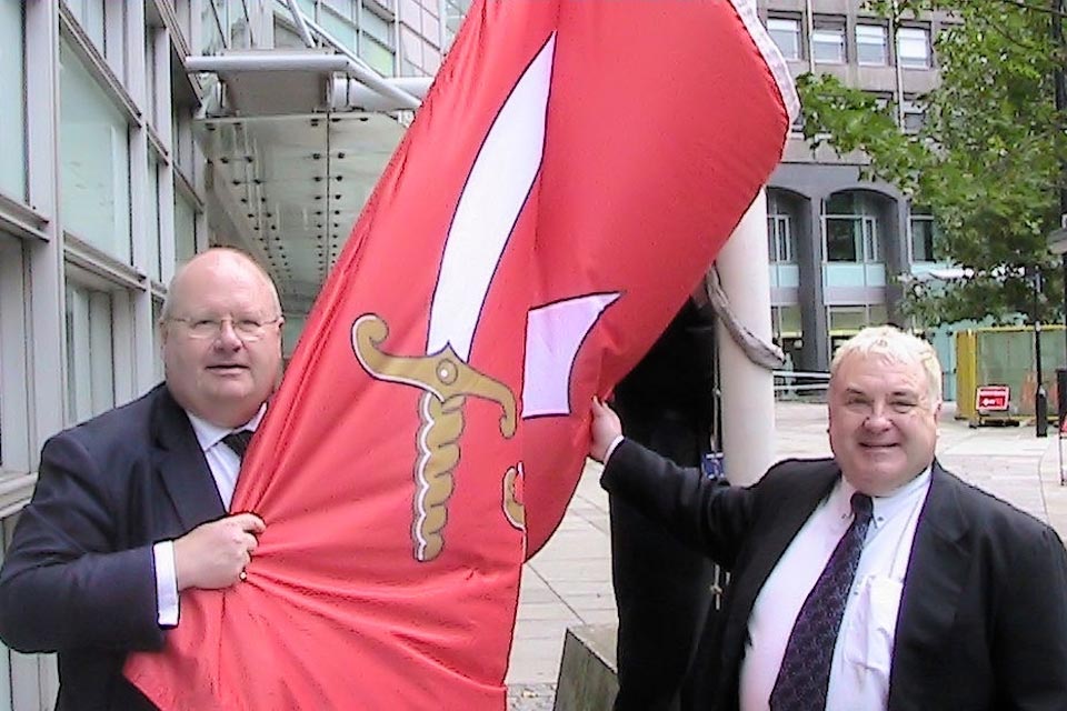 Eric Pickles and Russell Grant hold the Essex flag