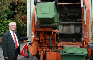 Bob Neill next to a rubbish van