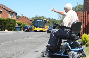 passenger in wheelchair waiting for bus