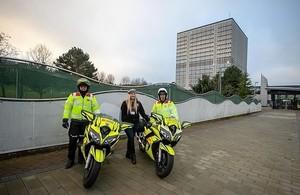 2 men and 1 woman standing by 2 motorcycles outside the Driver and Vehicle Licensing Agency in Swansea