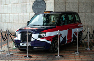 Electric taxi with union jack markings on display at a zero emissions vehicle summit.
