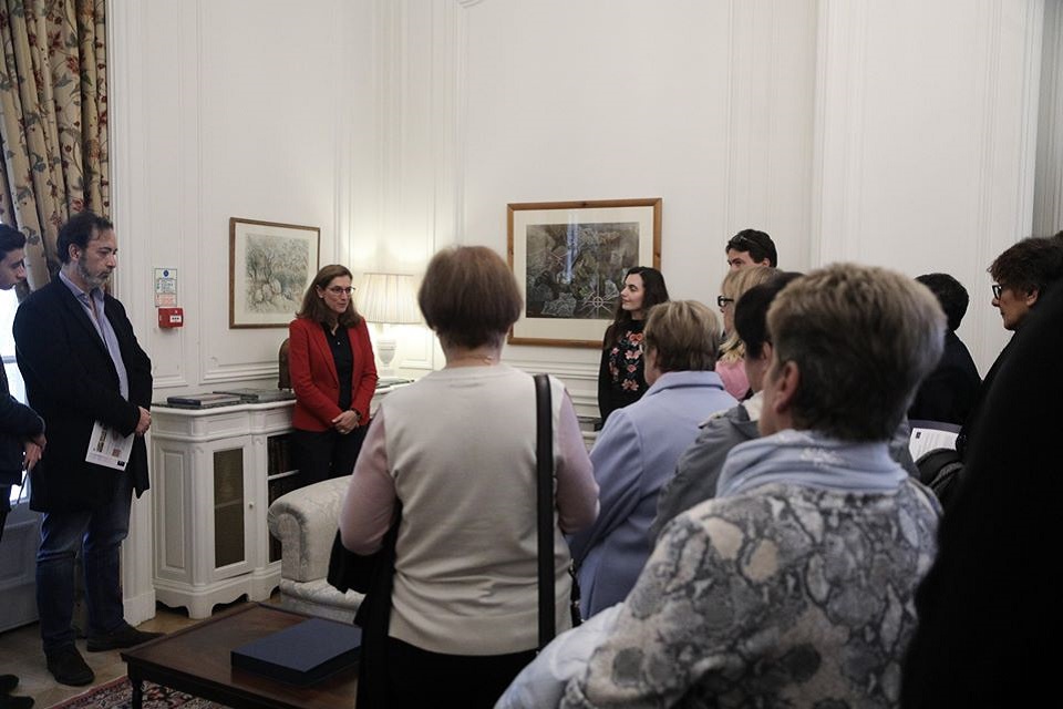 Visitors learning about paintings