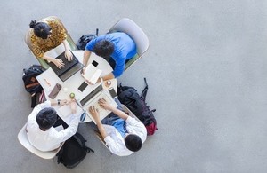 Group of young people seated together at a round table