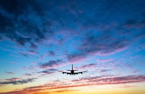 Plane flying into the sunset