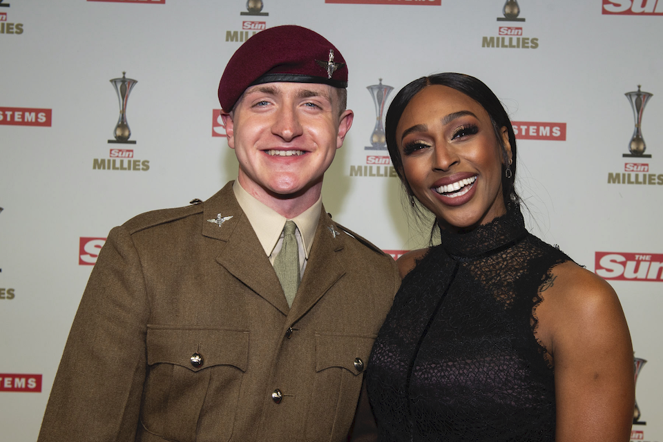 Pte Fin Doherty stands with Alexandra Burke on the red carpet