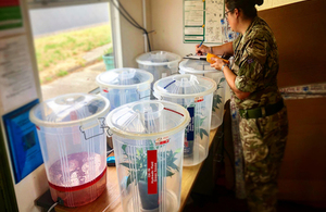 A servicewoman working with materials to produce recyclable products.