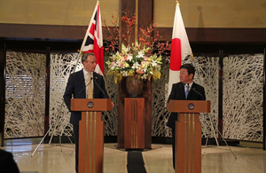 Foreign Secretary, Dominic Raab standing at a podium alongside the Japanese Foreign Minister Toshimitsu Motegi