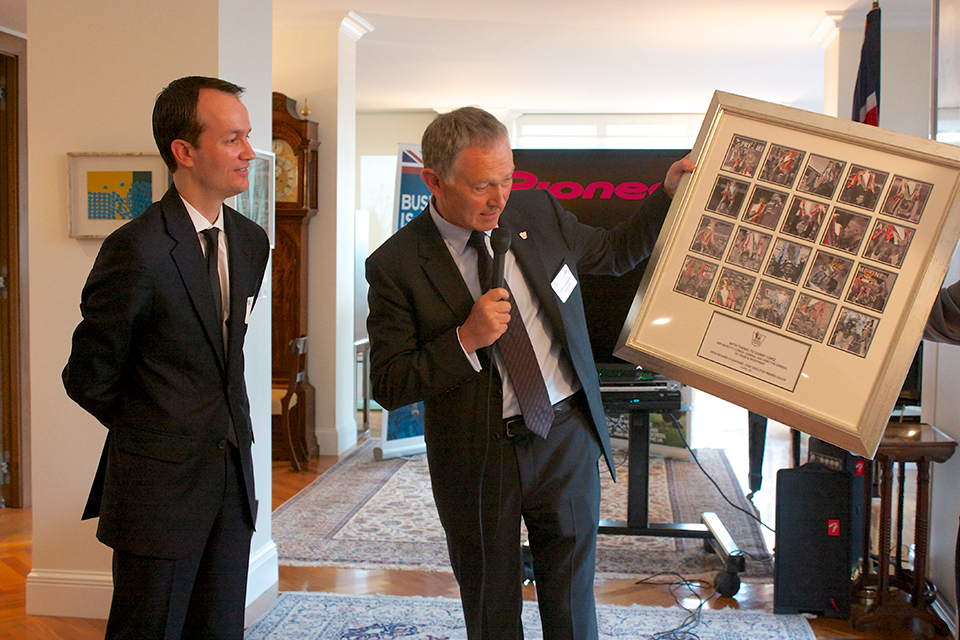 Richard Scudamore presents Danny Lopez with a framed gift.