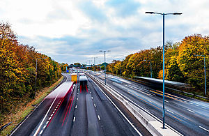 Street lamps over motorway traffic