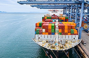 Image of large ship loaded with colourful shipping containers