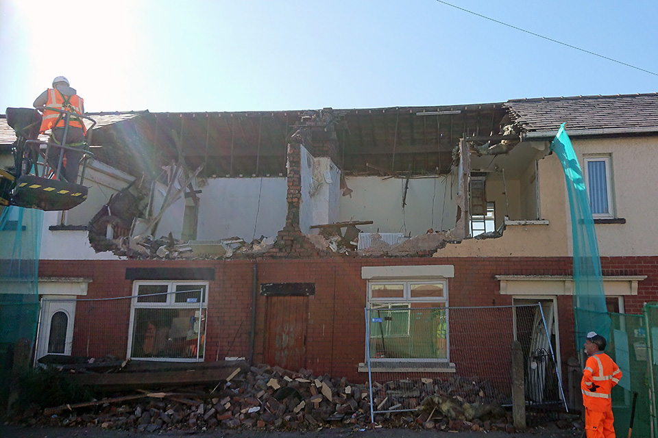 The damaged properties being demolished by hand.