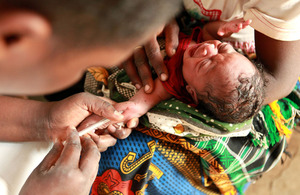 A nurse administers a diphtheria, tetanus and polio injection to a baby in Nyanza, Kenya.