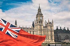 Red ensign in front of houses of parliament