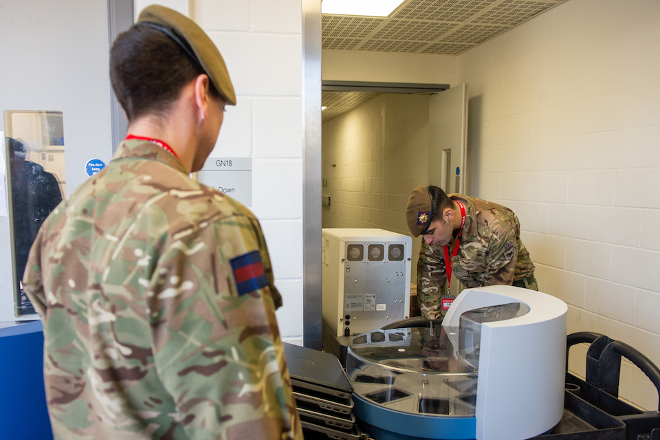 Members of the Coldstream Guards delivering testing equipment. MOD Crown Copyright.