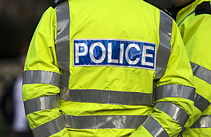 Cropped image of a police officer from behind