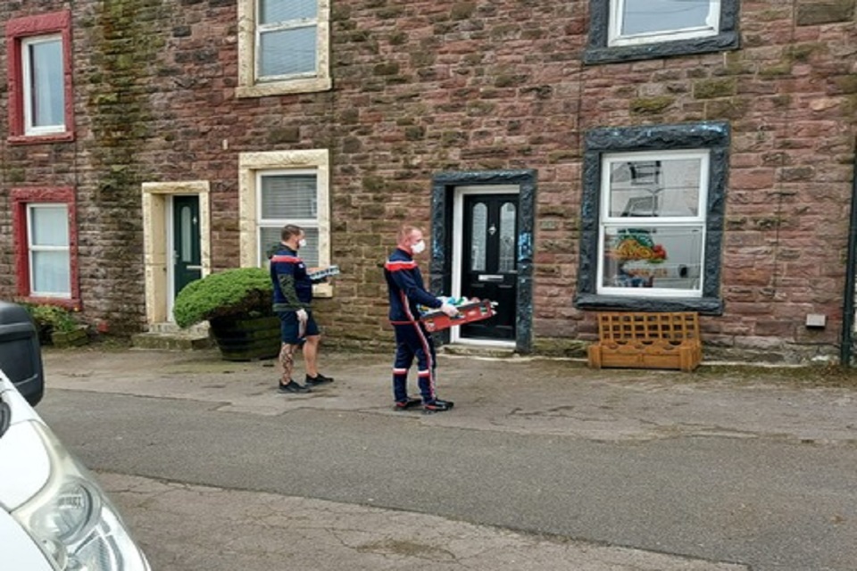 Volunteers outside delivering supplies to the community