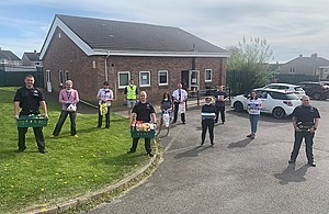 Volunteers standing outside the volunteer hub