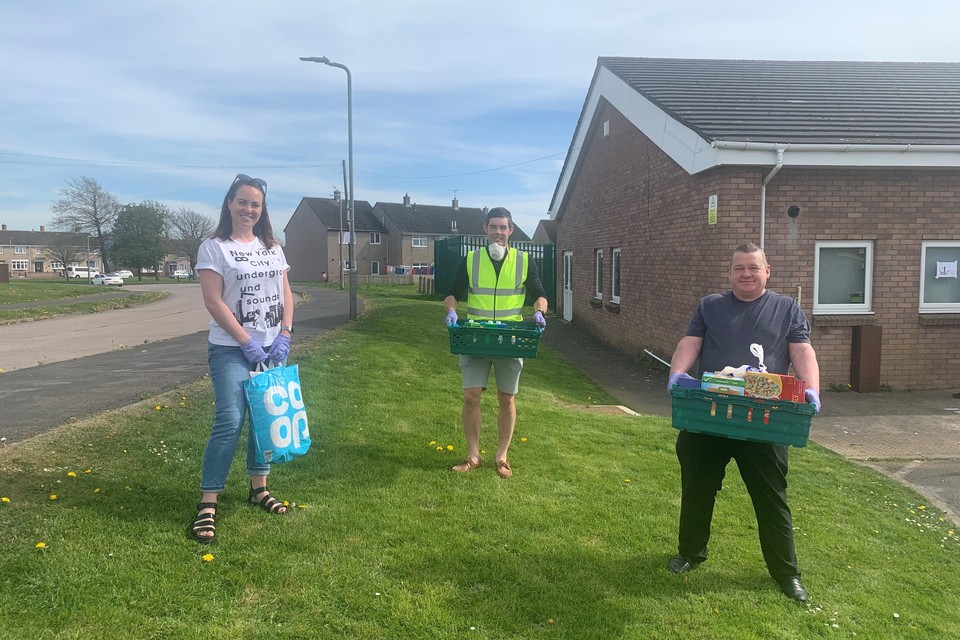 Volunteers standing outside the volunteer hub