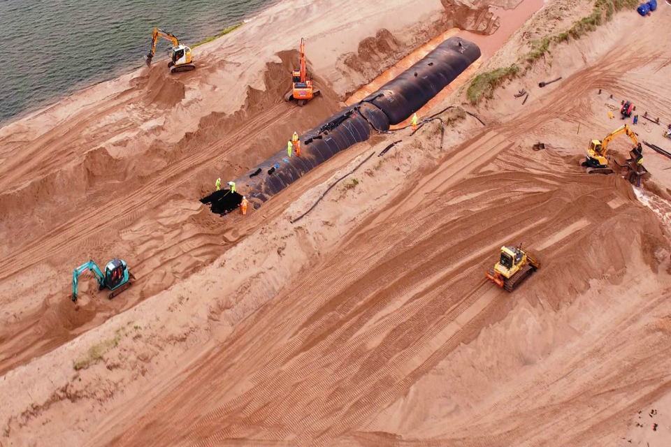 An aerial view of the giant bags of sand being buried beneath the dunes at Dawlish Warren.