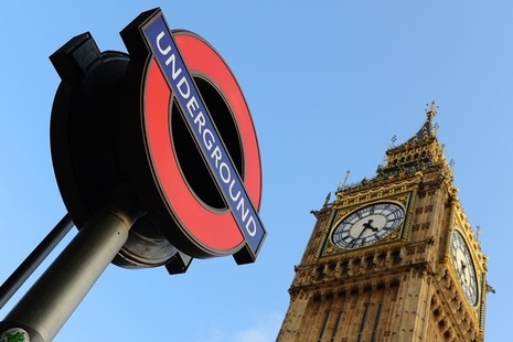London Underground sign next to the top of Big Ben.