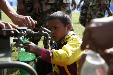 A Nepalese boy collects water from a pump installed by British Gurkhas after the earthquake which hit the country in April 2015. Picture: Jess Lea/DFID