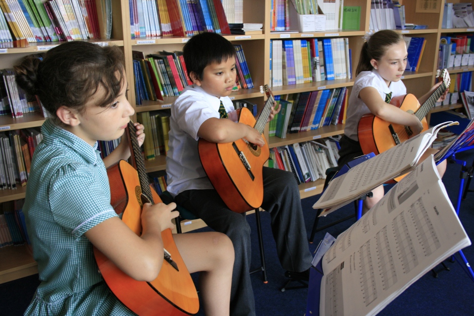 Pupils playing guitar