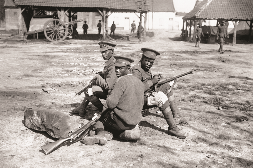 Men of the British West Indies Regiment cleaning their rifles, Albert-Amiens Road, September 1916. © IWM (Q 1201)