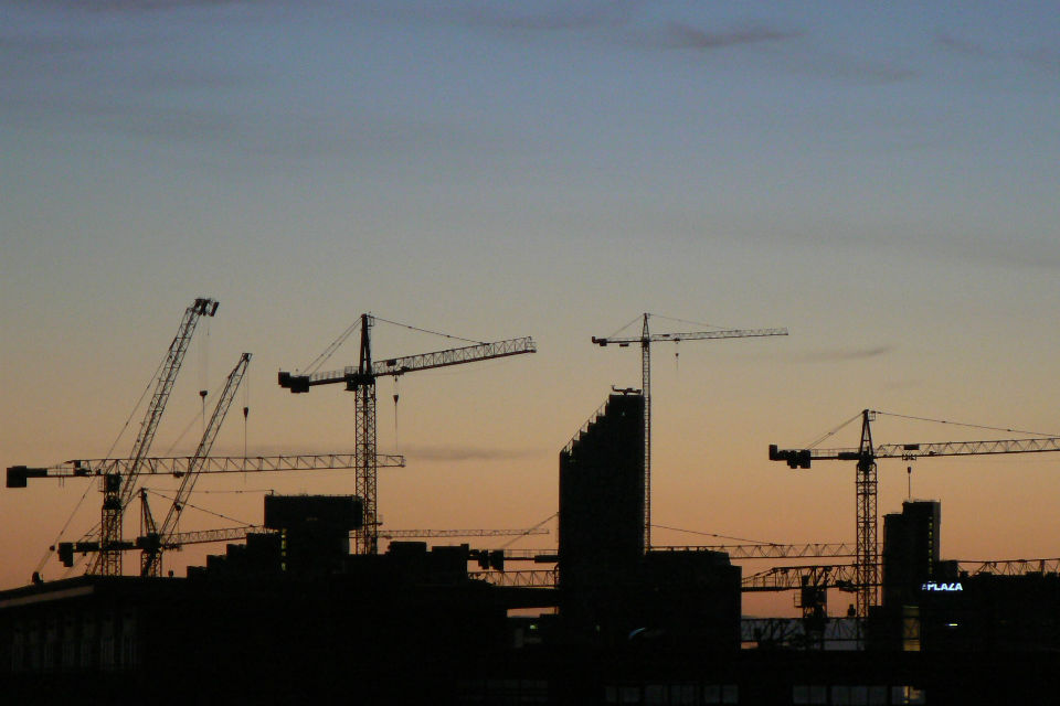 Silhouettes of cranes against the skyline (credit: peterallen/CC BY-SA 2.0)