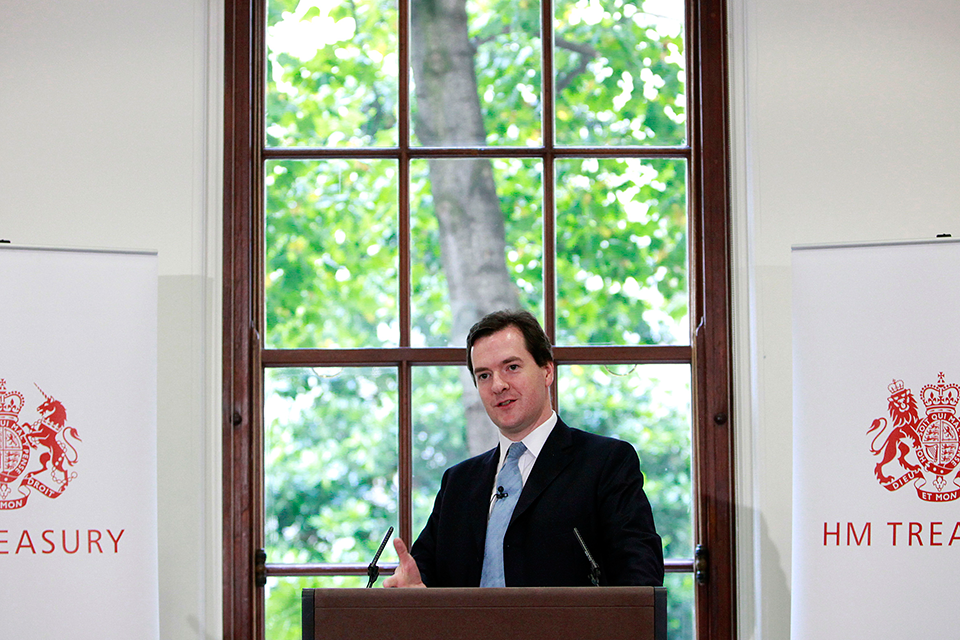 The Chancellor of the Exchequer, Rt Hon George Osborne MP, standing at a lectern to deliver a speech at HM Treasury in London.