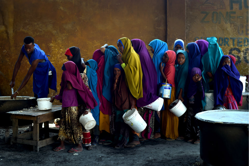 Young girls line up at a feeding centre in Mogadishu. UN Photo/Tobin Jones